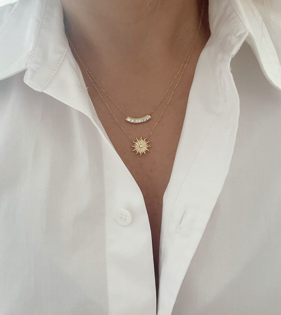 Add a touch of radiance to your outfit with our Sun Necklace. Made with 14ct gold plated sterling silver and a sparkling zirconia stone